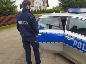 policjantka, radiowóz oraz starsza kobieta która znajduje się w radiowozie